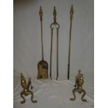 A brass three-piece companion set comprising fire tongs,