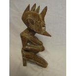 An African carved wood figure of a stylised male 12" high