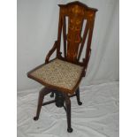 An Art Nouveau inlaid mahogany swivel office chair with floral decorated back and upholstered seat