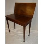 A 19th Century mahogany rectangular turnover top tea table on square tapered legs with capped feet