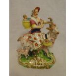 A 19th Century porcelain figure of a female with children riding a goat,