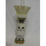 A Continental china oil lamp in the form of an owl with metal mounts and opaline shade,