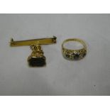 A Victorian 18ct gold dress ring set three sapphires and four small diamonds and a 19th Century fob