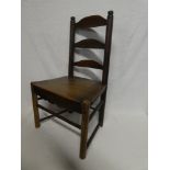 An early 19th Century ash and elm child's ladder back chair with polished seat on turned supports