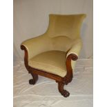A Victorian carved mahogany easy chair with scroll-shaped arms on paw feet