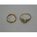 An 18ct gold dress ring set a small diamond and a 22ct gold wedding band