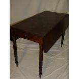 A Victorian mahogany rectangular drop leaf Pembroke table with a drawer in one end on turned