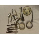 A selection of various silver condiment cutlery, spoons, silver circular ashtray,
