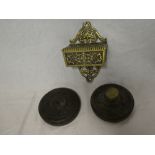 Two cast iron circular bank paperweights for the Union Bank of London and small brass wall mounted