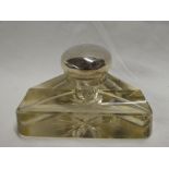 A glass angular ink well with silver mounted hinged lid,