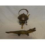 An Art Nouveau copper and brass spirit kettle with cane-bound handle and a brass crocodile