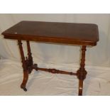 A Victorian walnut rectangular centre table on turned columns joined by an under-stretcher