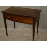 A late Victorian mahogany rectangular side table with a curved drawer in the frieze on square