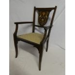 An Edwardian inlaid mahogany child's-size open armchair with decorated shield-shaped back and