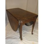 A 19th Century mahogany oval drop leaf dining table on tapered legs with pad feet (af)