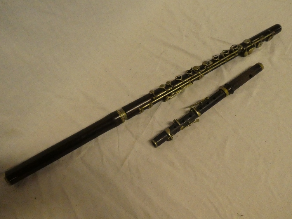 A nickel mounted rosewood three-piece flute and a rosewood piccolo (2)