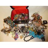 A jewellery box containing a large selection of various costume jewellery