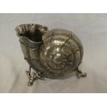 A silver plated spoon warmer in the form of a nautilus shell on scroll legs