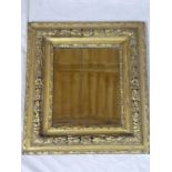 A rectangular wall mirror in ornate gilt rectangular frame,