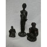 A Derbyshire pottery figure of an African female with child and two other similar Derbyshire