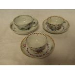 A pair of 18th Century tea bowls and saucers with painted floral decoration and one other early