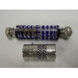 An Edward VII silver cylindrical scent bottle with blue glass liner and hinged cover,