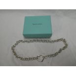 A Tiffany silver chain-link necklace with heart emblem in Tiffany box