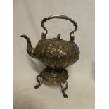 A late Victorian silver plated spirit tea kettle and stand with raised floral decoration and scroll
