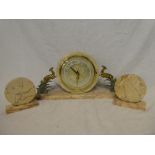 An Art Deco mantel clock with circular dial in polished marble case flanked by a pair of gilt