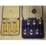 A set of six silver coffee spoons with angular handles,
