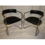 A set of four 1970's chromium plated curved dining chairs upholstered in black vinyl with matching