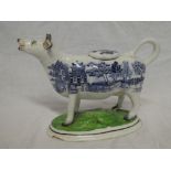 A 19th Century Staffordshire pottery cow creamer with blue and white willow transfer decoration on