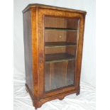 A Victorian inlaid walnut music cabinet with leather mounted shelves and compartments enclosed by a