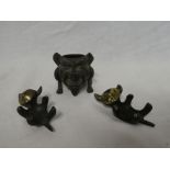 A pair of gilt bronze figures of recumbent cats,