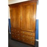 An early 19th Century mahogany linen press, the base with six small drawers with brass ring handles,