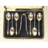 A set of six George V silver apostle teaspoons with matching sugar tongs,