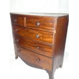 A Victorian mahogany bow front chest of two short and three long drawers with turned handles on