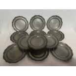 Twelve matching Continental pewter circular plates,