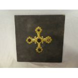 An unusual gilt brass cross emblem decorated with five tiger's eye panels ,