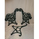 A pair of Victorian cast iron garden bench ends with floral and scroll decoration together with