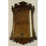 A George III mahogany framed rectangular wall mirror with gilt slip,