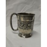 An Edward VII silver christening tankard with raised scroll decoration and loop handle,