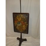 A Victorian rosewood pole screen with needlework floral tapestry panel on turned and carved column