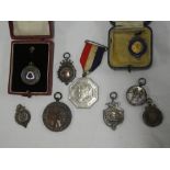 A selection of various silver sporting medallions including Brighton & Hove Football League 1924-25,