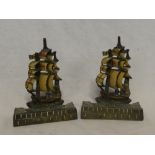 A pair of painted bronze doorstops in the form of three masted sailing ships,
