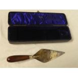 A silver plated presentation trowel "This trowel was used by Miss Ellis to lay the first brick of