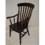 An old elm and beech lath-back kitchen carver armchair with polished seat on turned legs