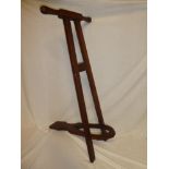 An old mahogany full length folding boot jack with turned handles