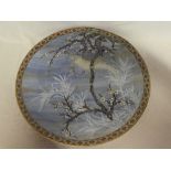 A 19th Century Japanese pottery circular charger with bird of prey and blossoming tree decoration,
