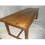 An 18th Century elm and oak refectory-style dining table with triple planked top on square-shaped